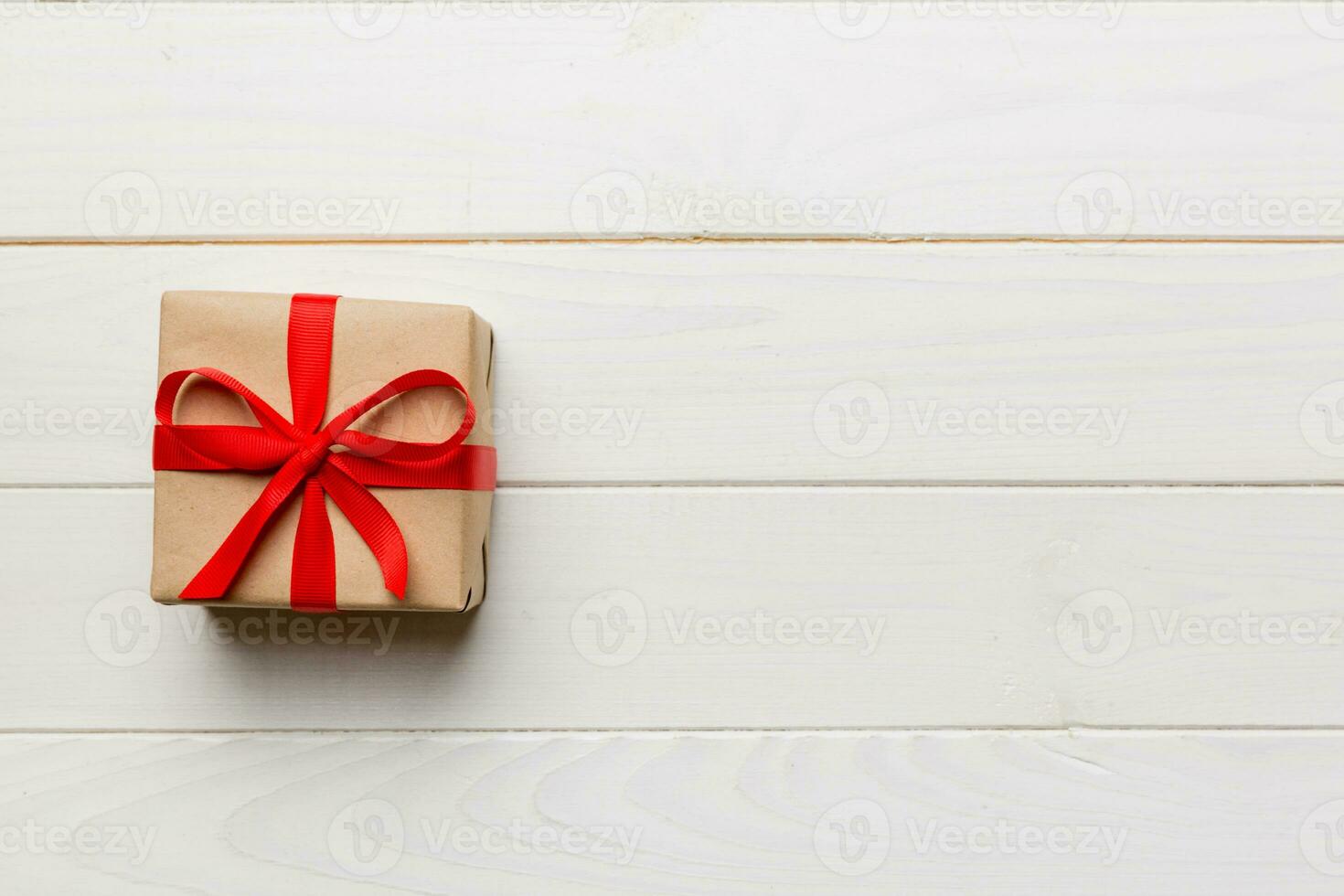 Valentine day composition red  gift box with bow and heart. Christmas present. View from above. Space for text. Holday greeting card photo