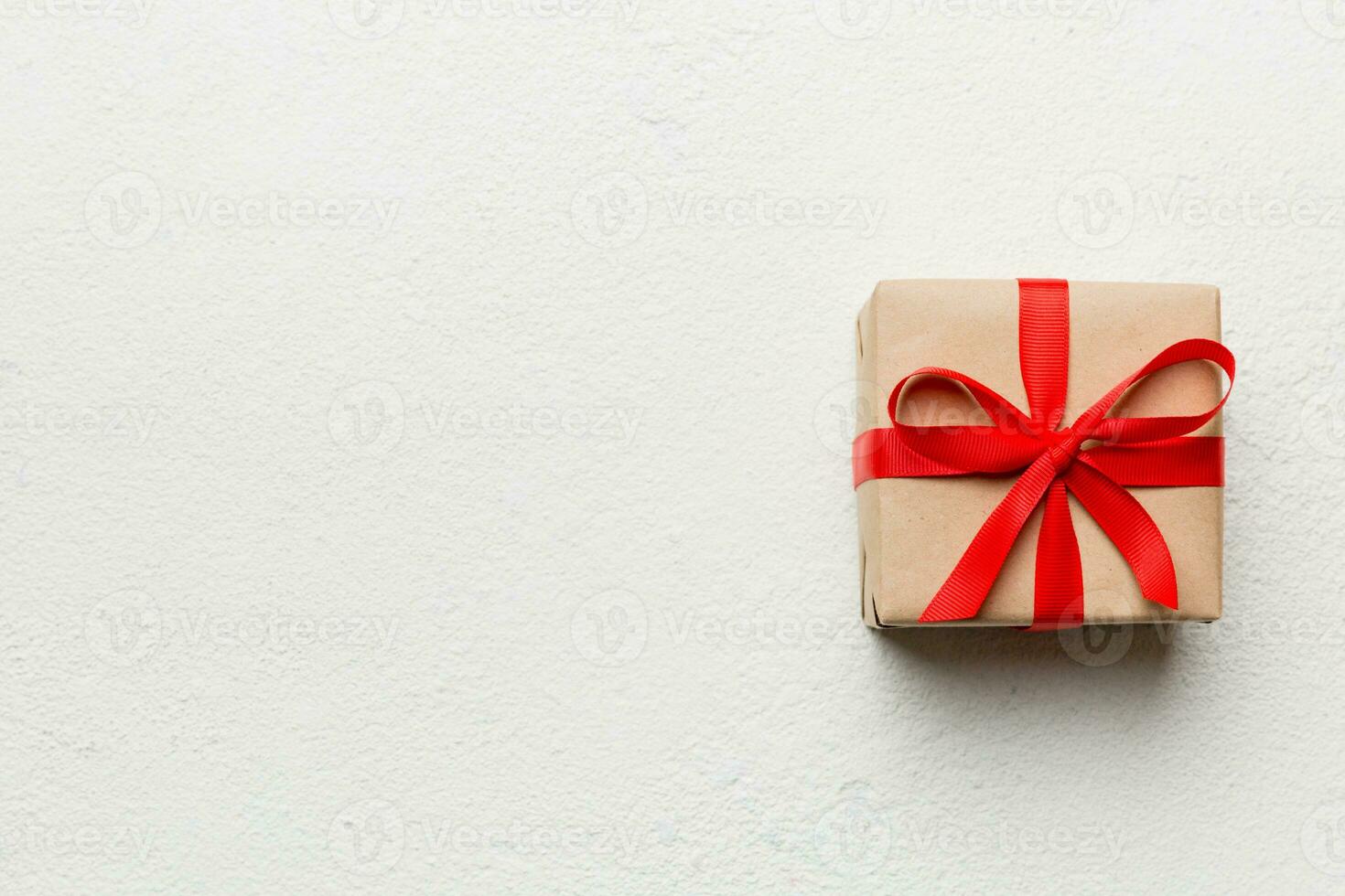 Valentine day composition red  gift box with bow and heart. Christmas present. View from above. Space for text. Holday greeting card photo