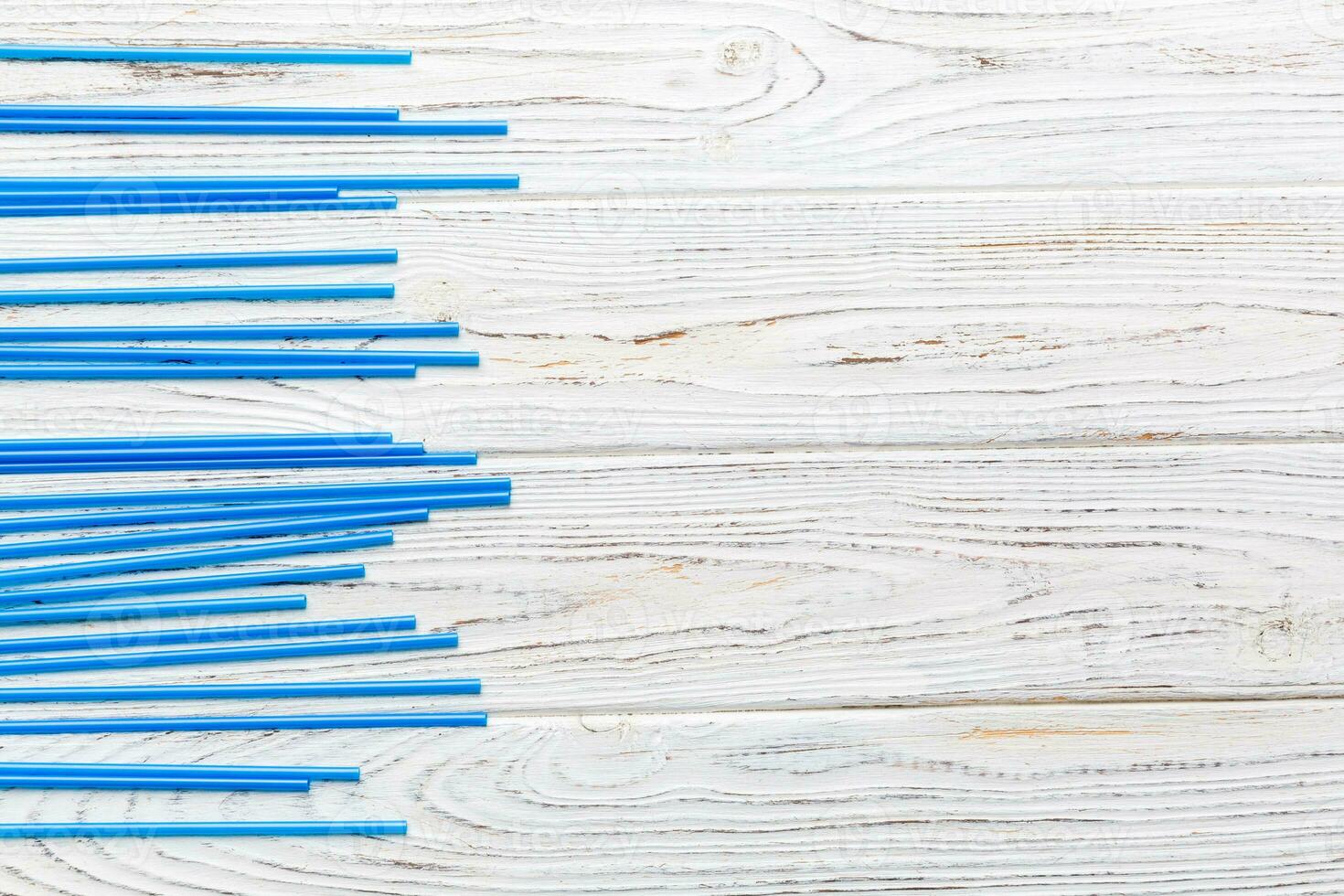 Heap of colorful plastic drinking straws on Colored background, flat lay. Copy Space for text photo