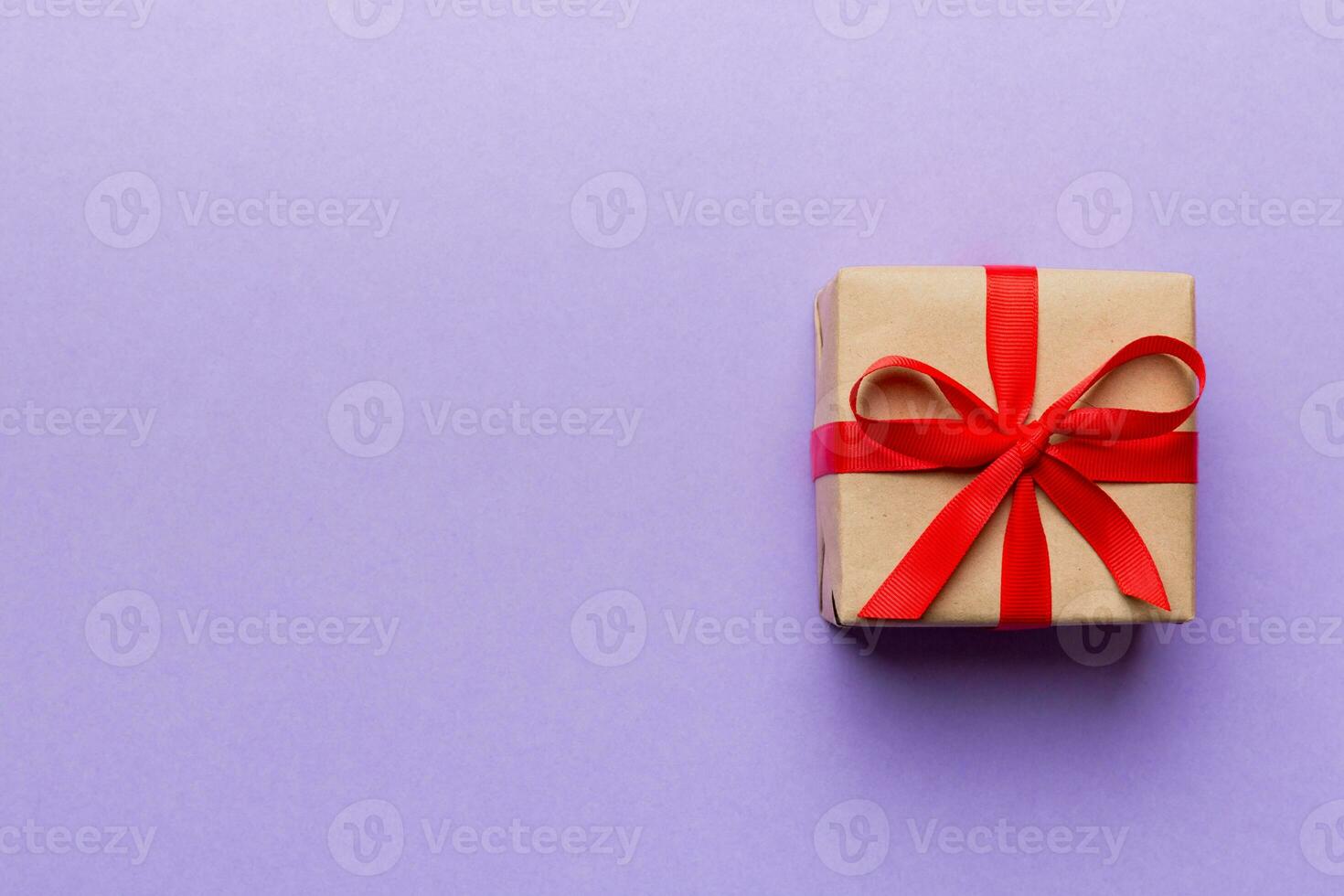 Valentine day composition red  gift box with bow and heart. Christmas present. View from above. Space for text. Holday greeting card photo