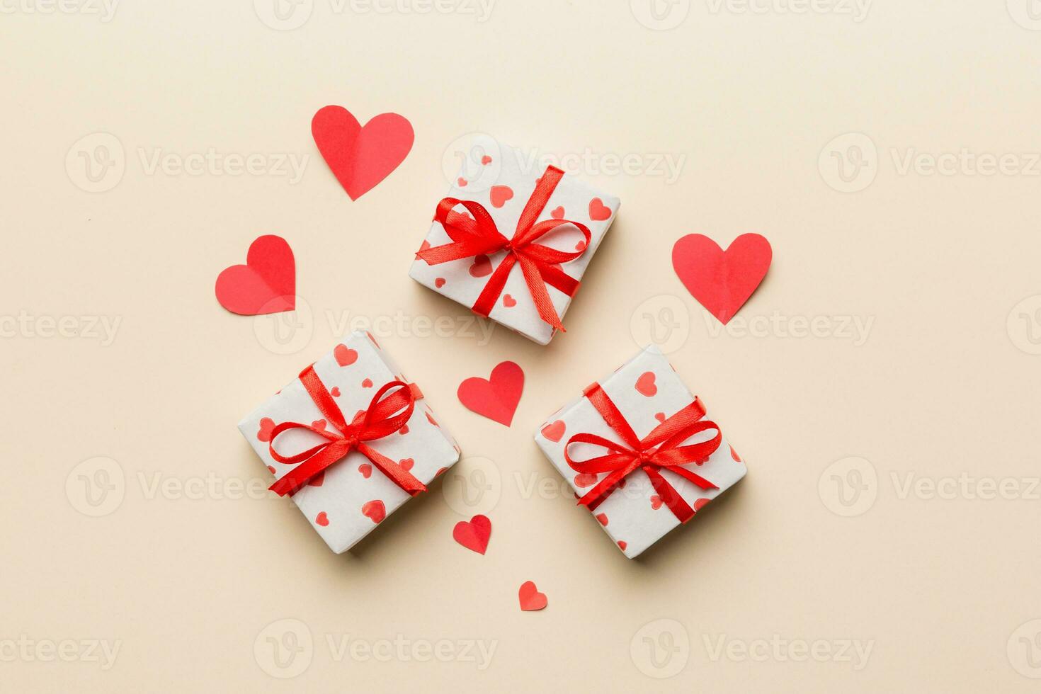 Valentine day composition red gift box with bow and heart. Christmas present. View from above. Holday greeting card photo
