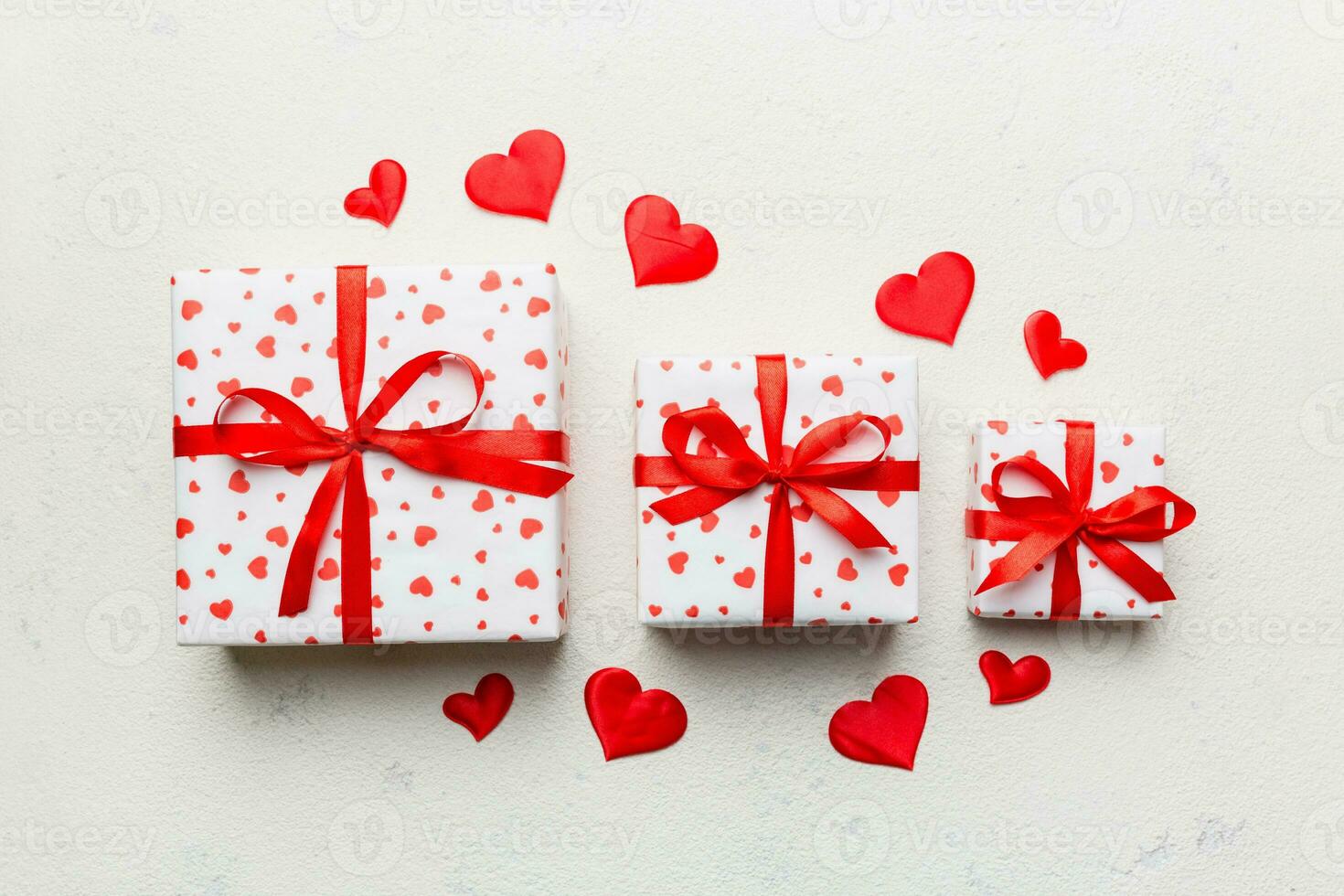 Valentine day composition red  gift box with bow and heart. Christmas present. View from above. Holday greeting card photo