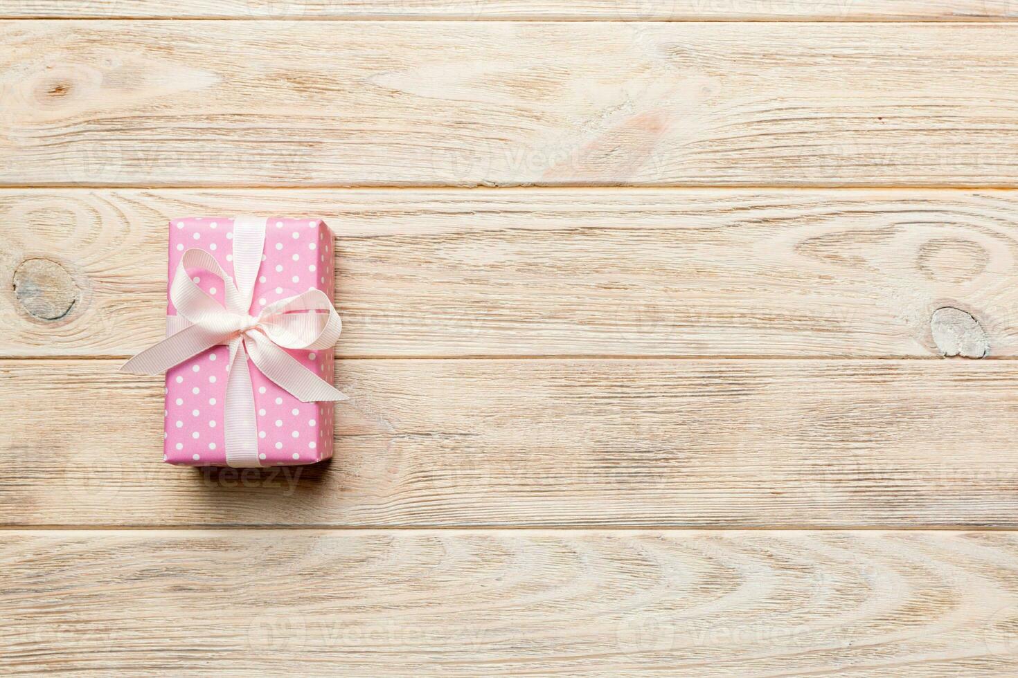Valentine day composition red gift box with bow and heart. Christmas present. View from above. Space for text. Holday greeting card photo