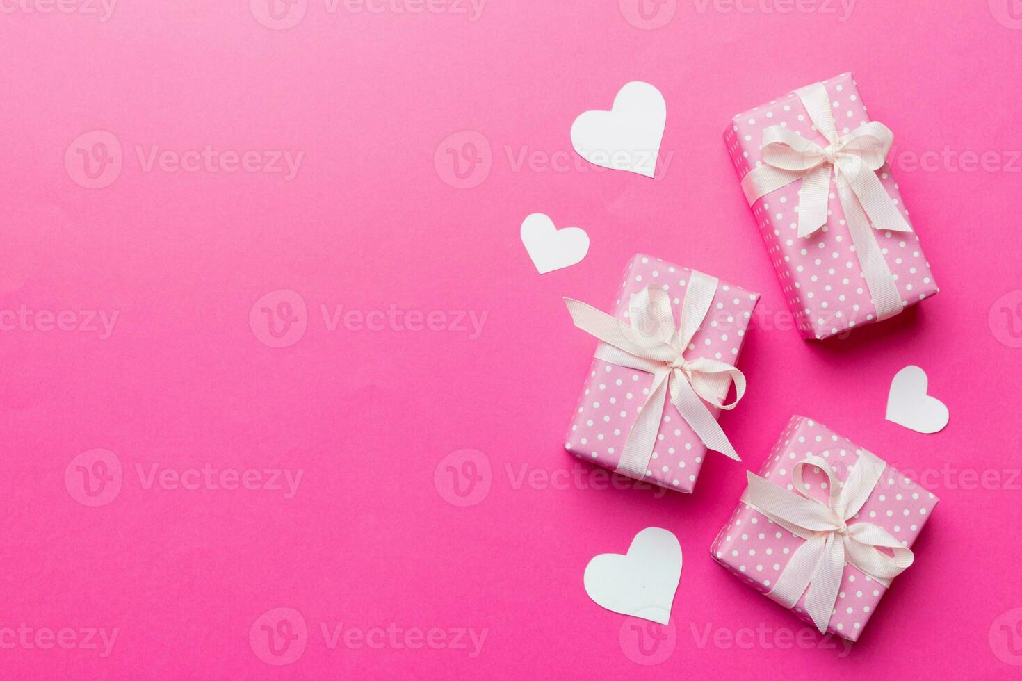 Valentine day composition red  gift box with bow and heart. Christmas present. View from above. Space for text. Holday greeting card photo
