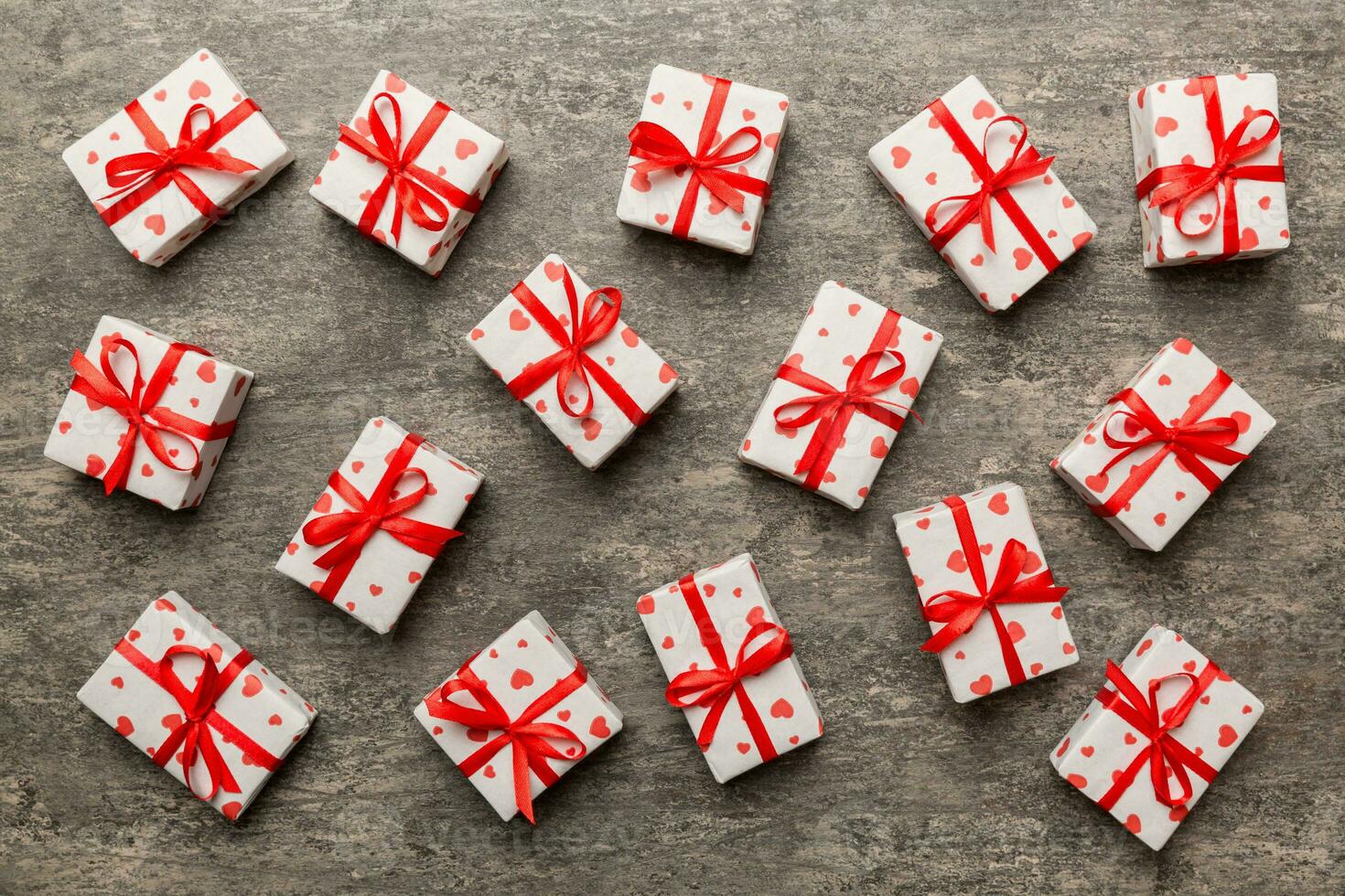 Valentine day composition red  gift box with bow and heart. Christmas present. View from above. Holday greeting card photo