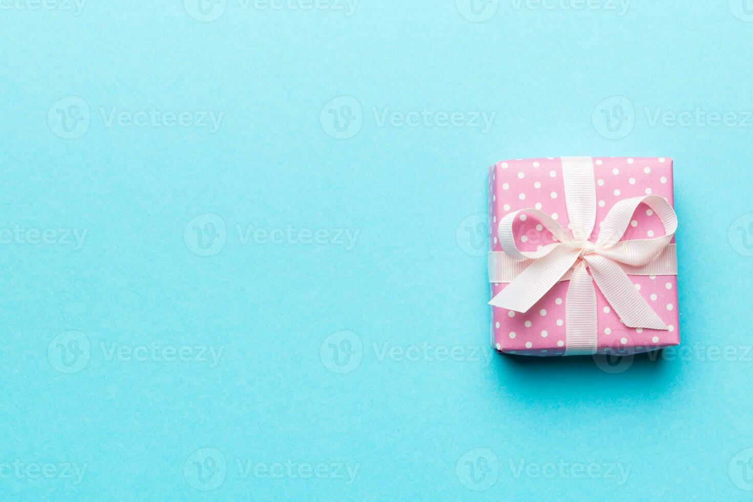 Valentine day composition red  gift box with bow and heart. Christmas present. View from above. Space for text. Holday greeting card photo