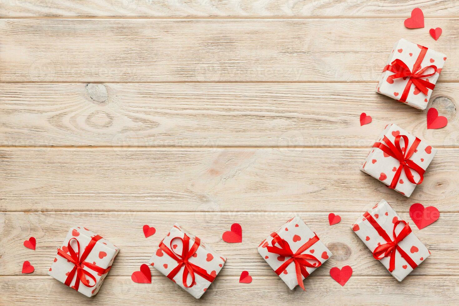 Valentine day composition red gift box with bow and heart. Christmas present. View from above. Space for text. Holday greeting card photo