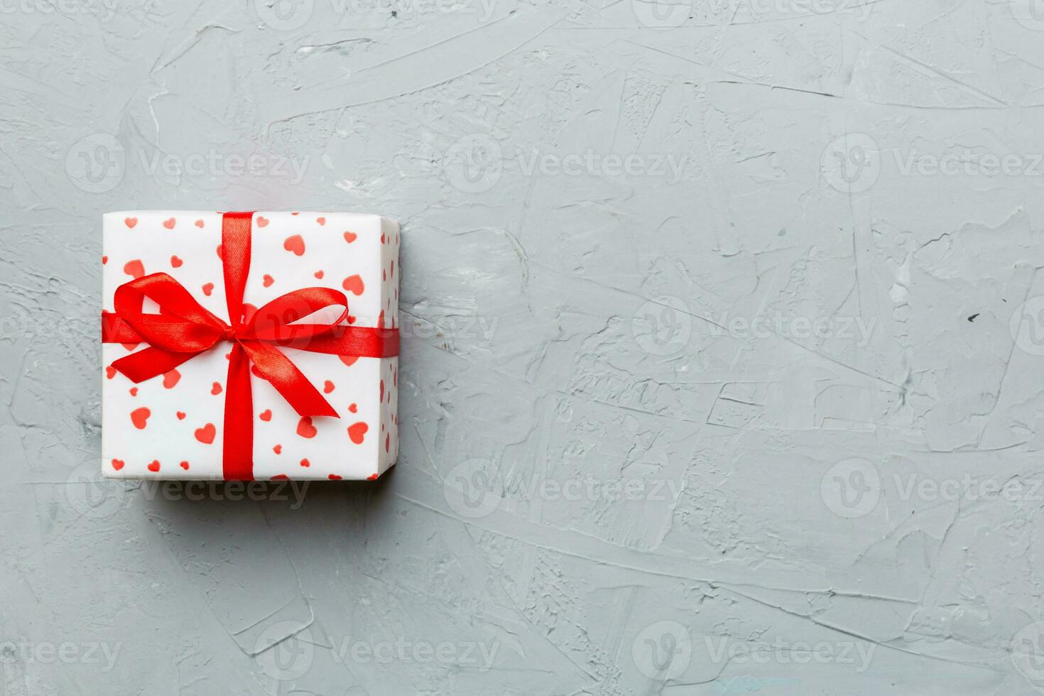 Valentine day composition red  gift box with bow and heart. Christmas present. View from above. Space for text. Holday greeting card photo