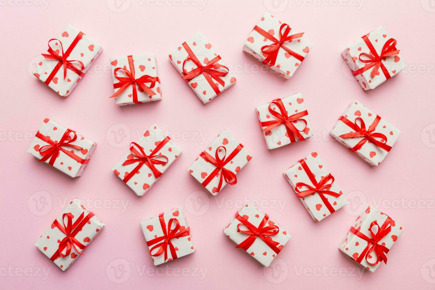 Valentine day composition red  gift box with bow and heart. Christmas present. View from above. Holday greeting card photo