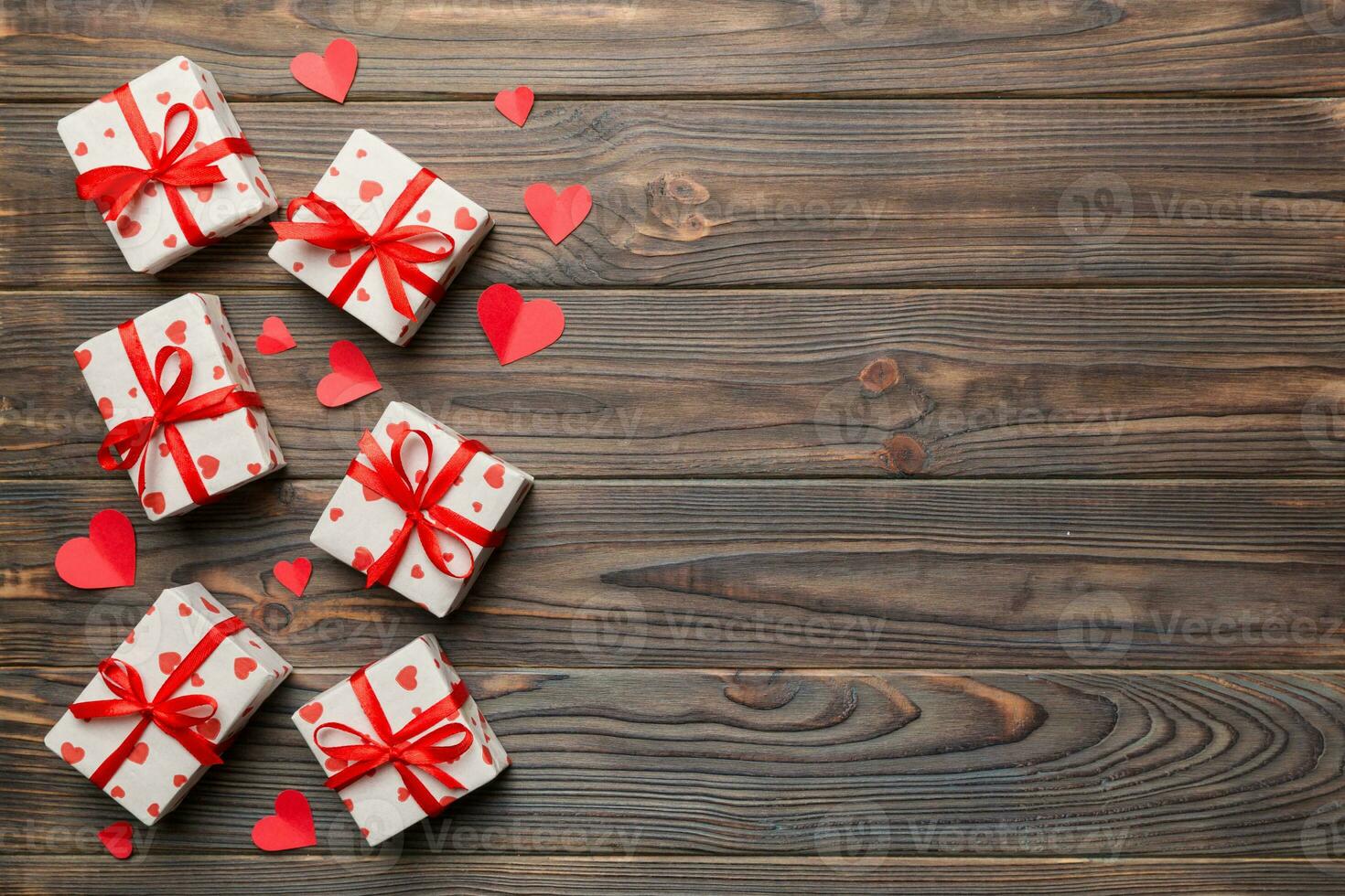Valentine day composition red  gift box with bow and heart. Christmas present. View from above. Space for text. Holday greeting card photo