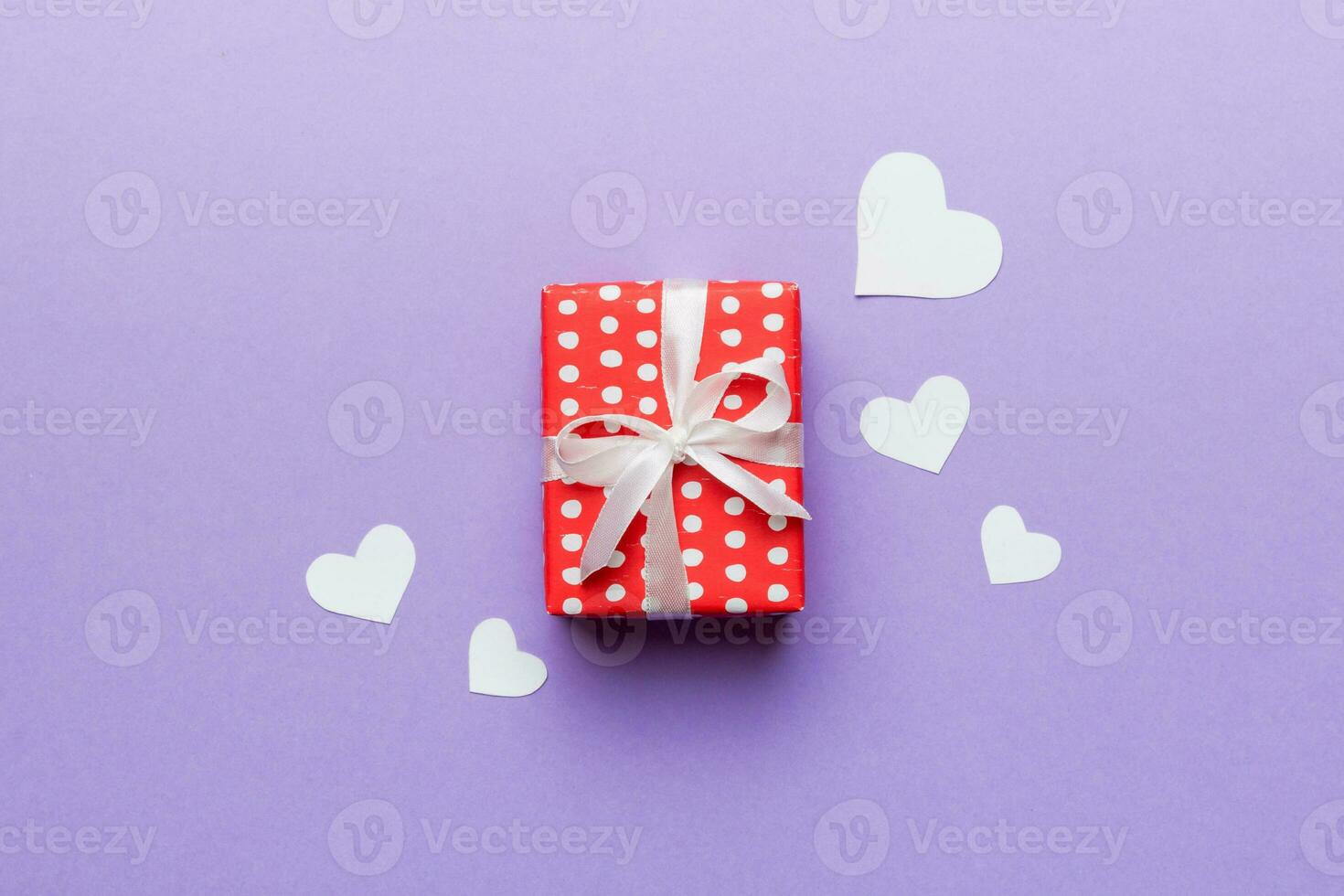 Valentine day composition red  gift box with bow and heart. Christmas present. View from above. Space for text. Holday greeting card photo
