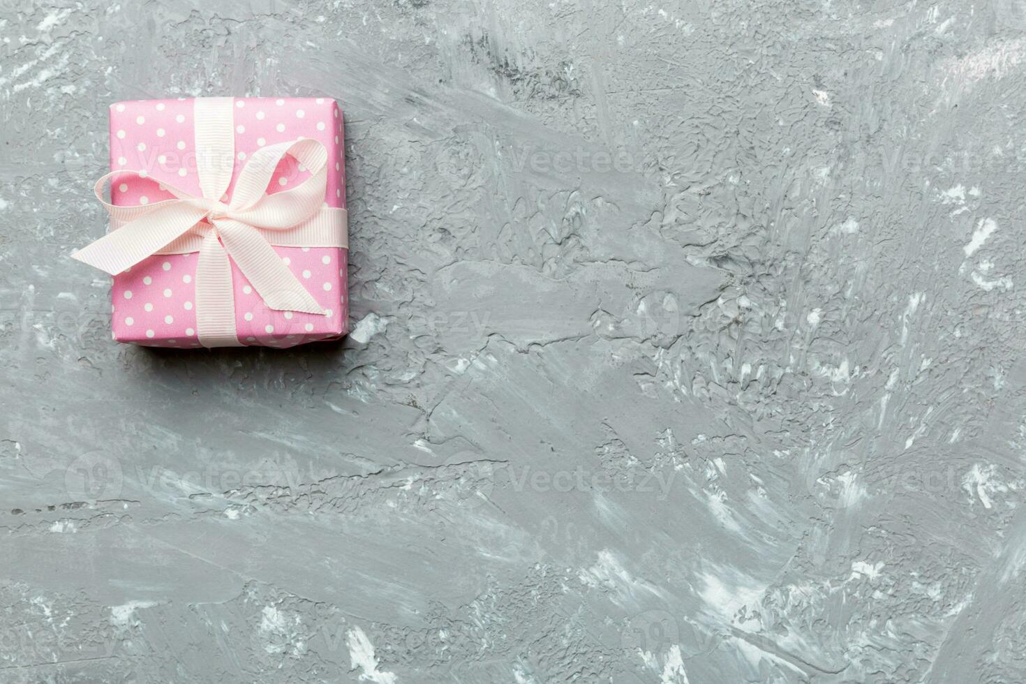 Valentine day composition red gift box with bow and heart. Christmas present. View from above. Space for text. Holday greeting card photo