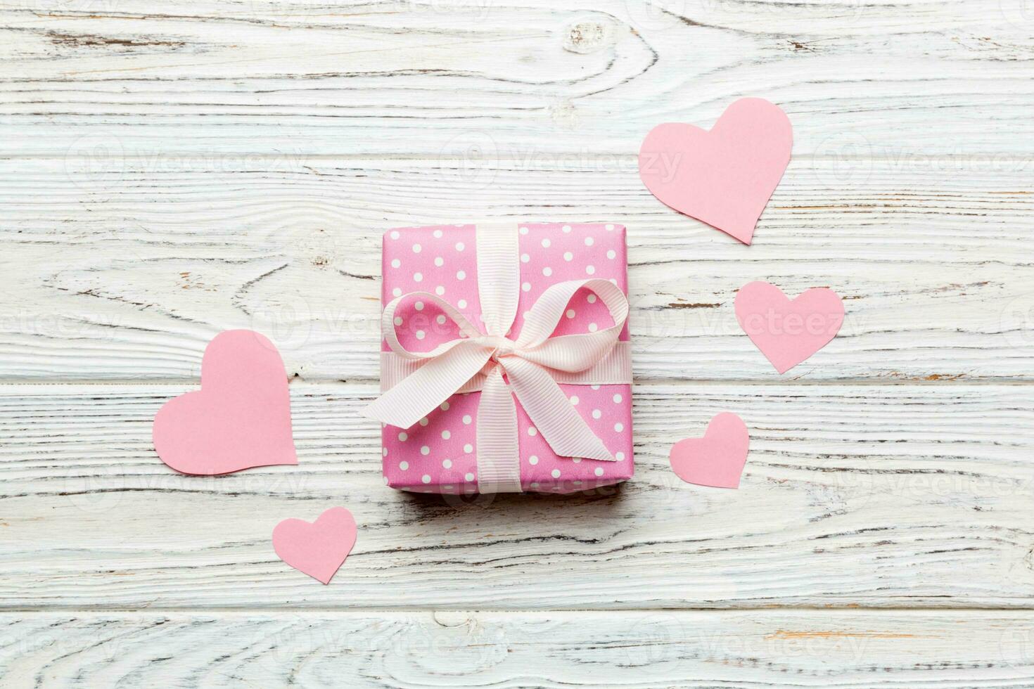 Valentine day composition red  gift box with bow and heart. Christmas present. View from above. Holday greeting card photo