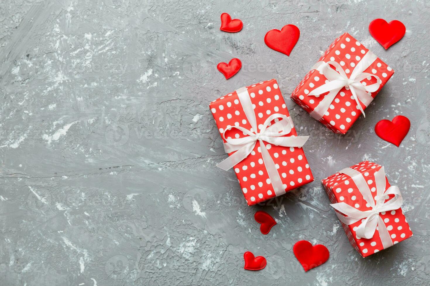 Valentine day composition red gift box with bow and heart. Christmas present. View from above. Holday greeting card photo