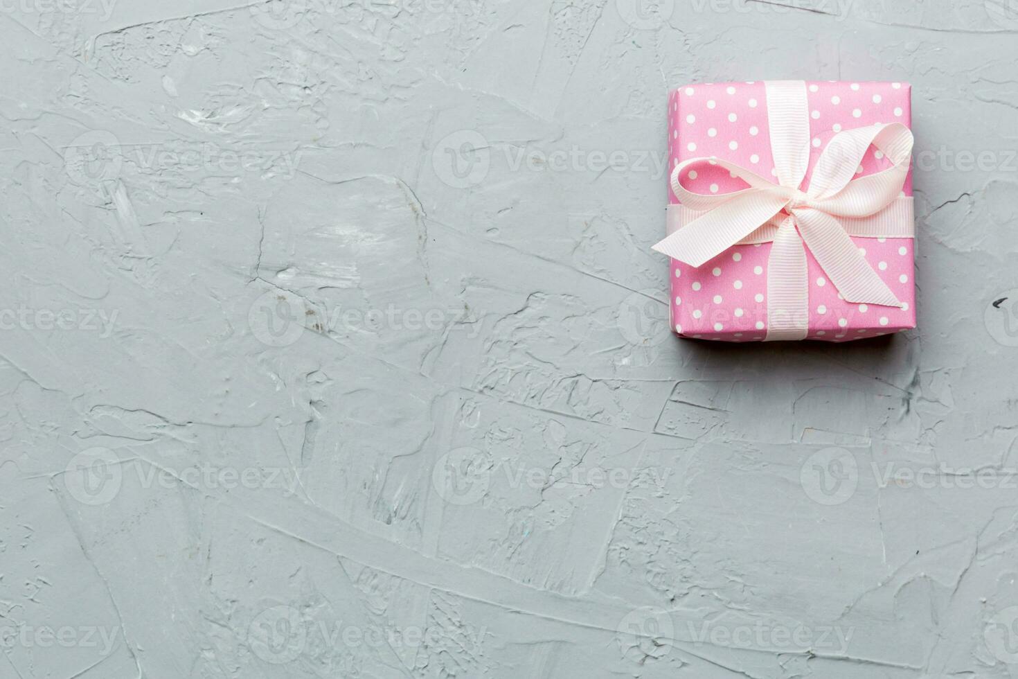 Valentine day composition red  gift box with bow and heart. Christmas present. View from above. Space for text. Holday greeting card photo