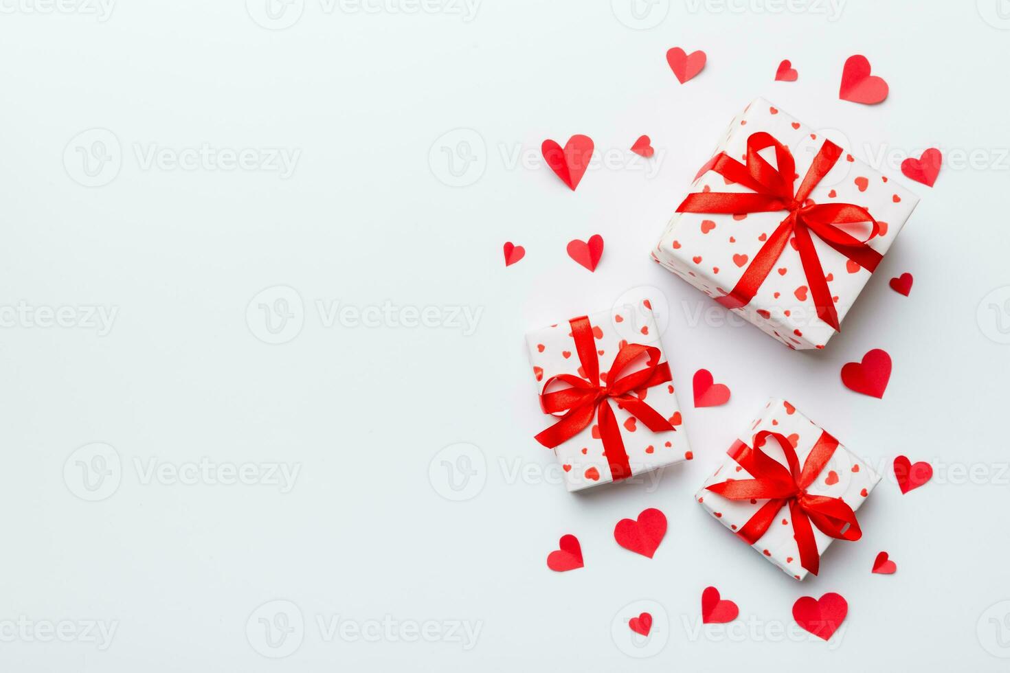 Valentine day composition red gift box with bow and heart. Christmas present. View from above. Space for text. Holday greeting card photo