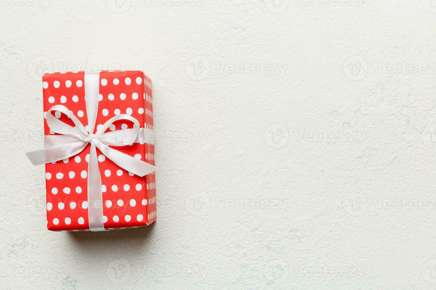 Valentine day composition red  gift box with bow and heart. Christmas present. View from above. Space for text. Holday greeting card photo