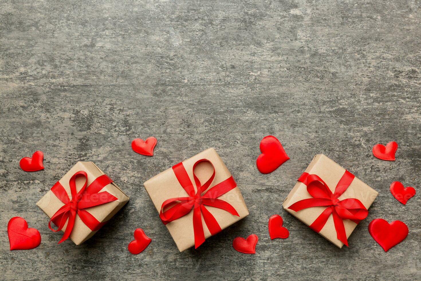 Valentine day composition red  gift box with bow and heart. Christmas present. View from above. Space for text. Holday greeting card photo