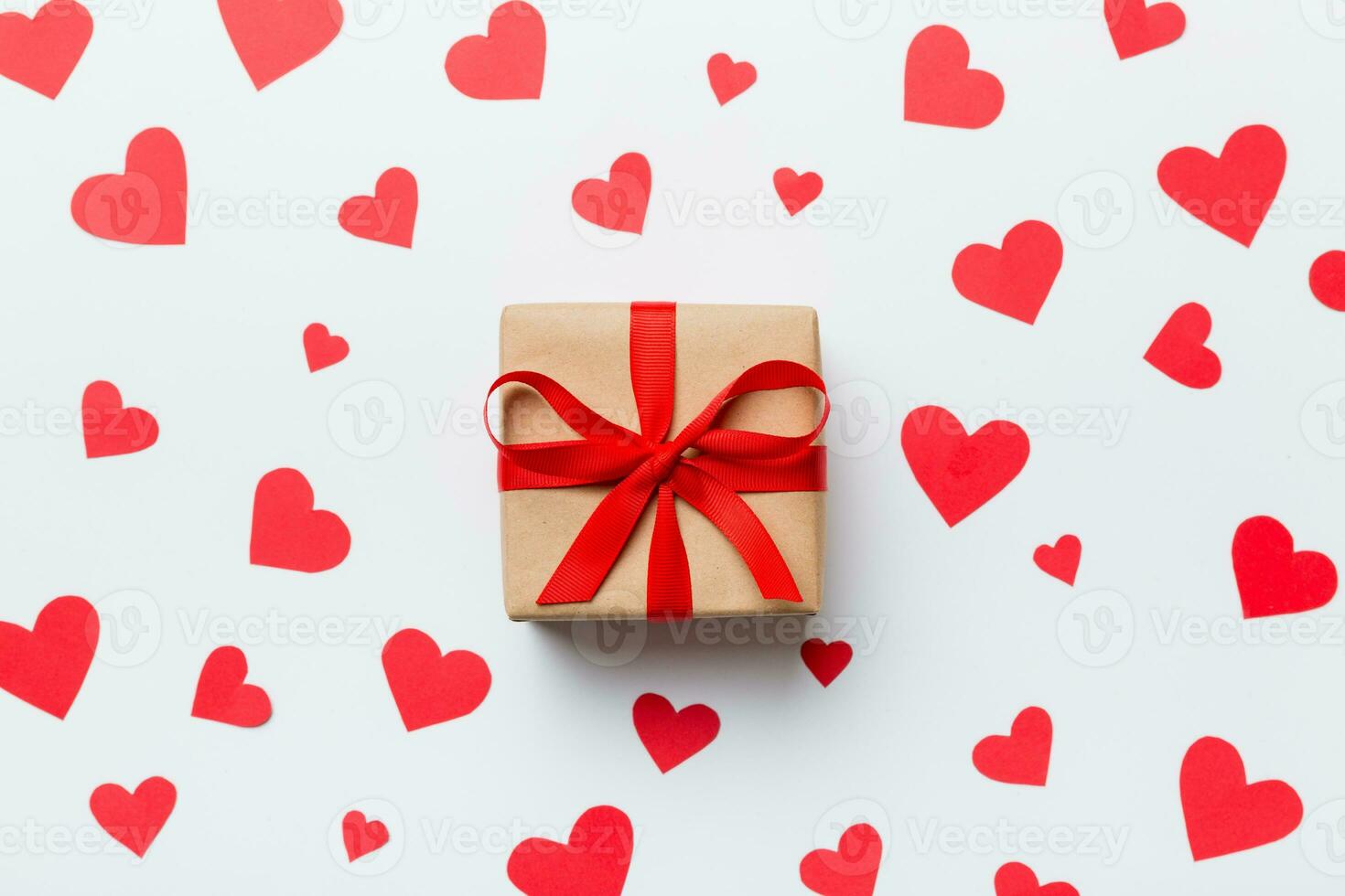 Valentine day composition red  gift box with bow and heart. Christmas present. View from above. Holday greeting card photo