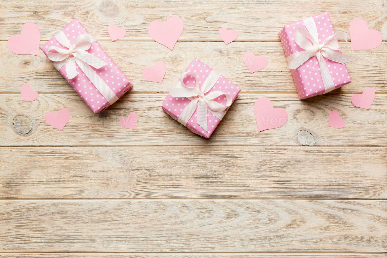 Valentine day composition red  gift box with bow and heart. Christmas present. View from above. Space for text. Holday greeting card photo