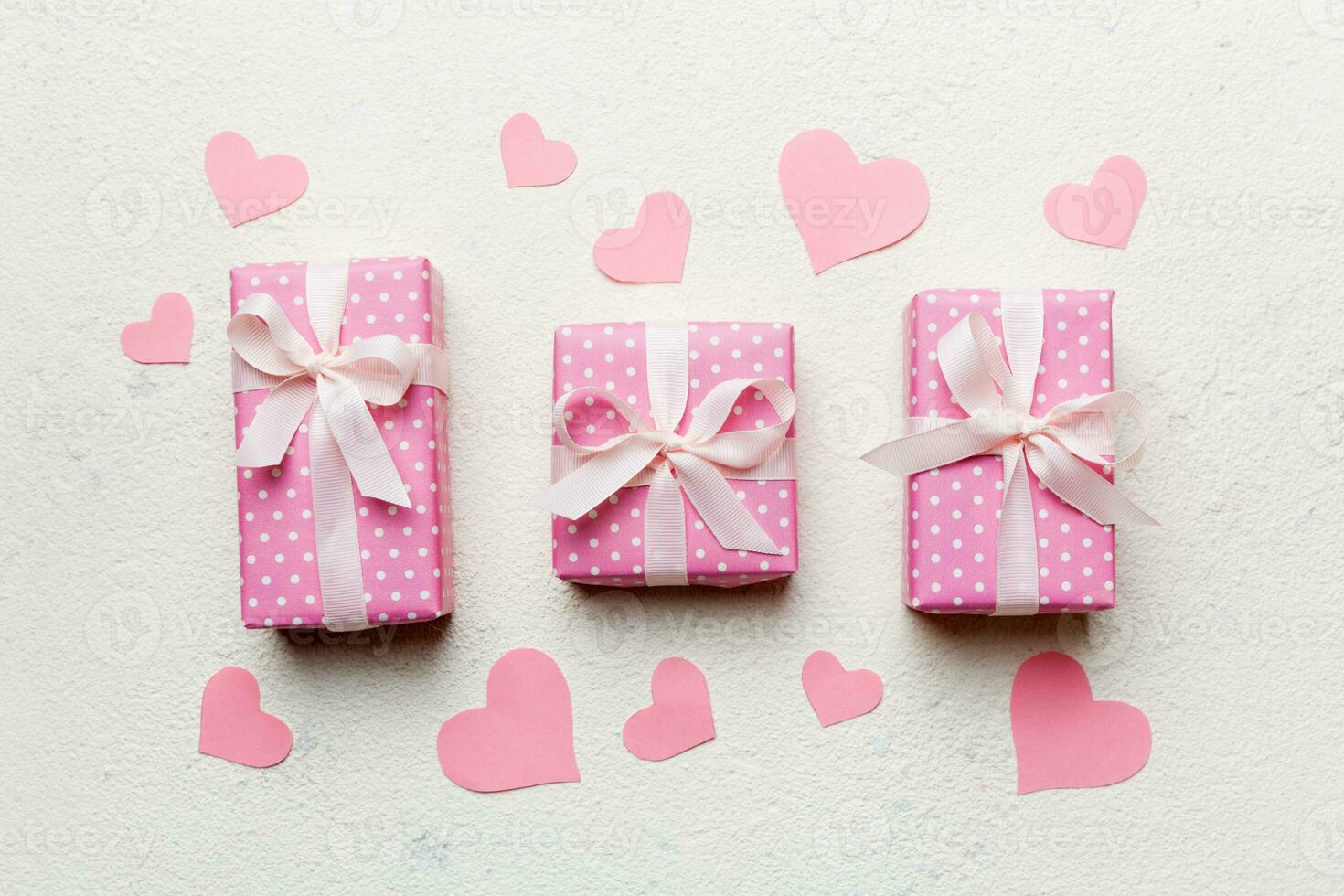Valentine day composition red  gift box with bow and heart. Christmas present. View from above. Holday greeting card photo