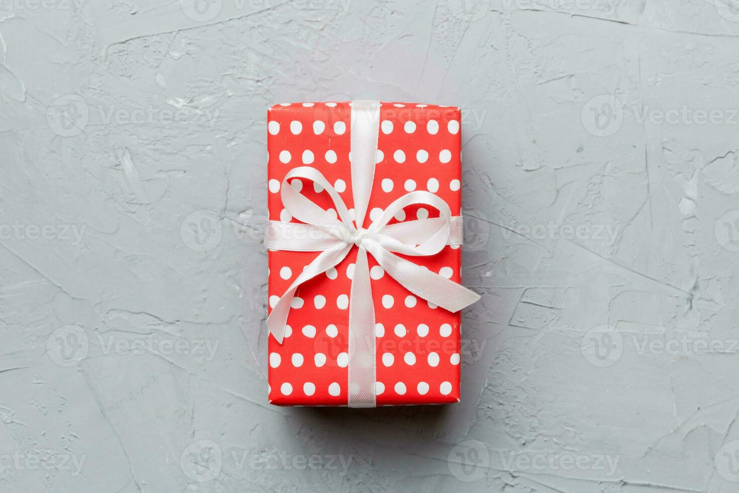 Valentine day composition red  gift box with bow and heart. Christmas present. View from above. Space for text. Holday greeting card photo
