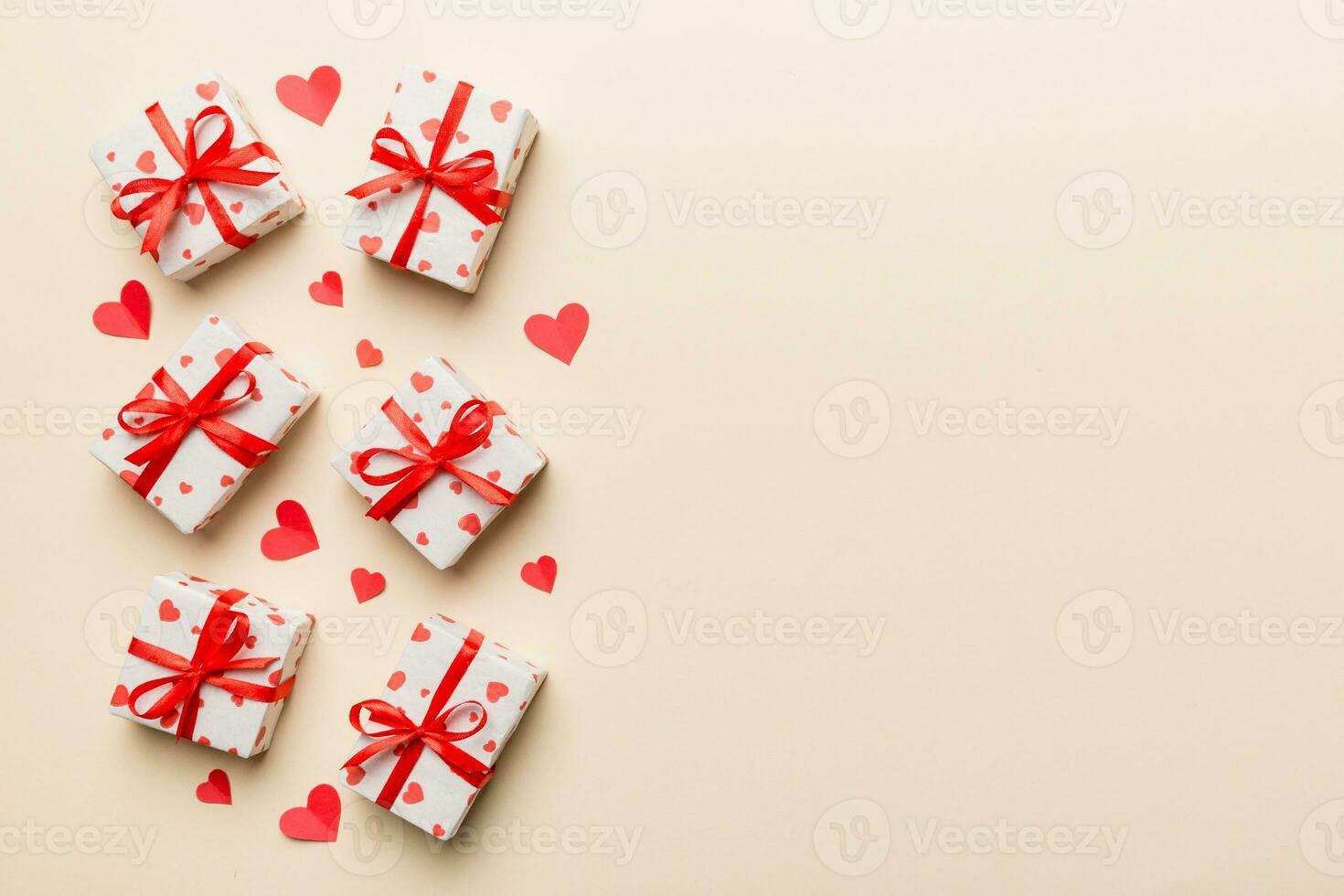 Valentine day composition red gift box with bow and heart. Christmas present. View from above. Space for text. Holday greeting card photo