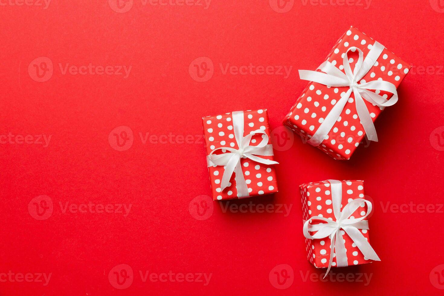 Valentine day composition red  gift box with bow and heart. Christmas present. View from above. Space for text. Holday greeting card photo