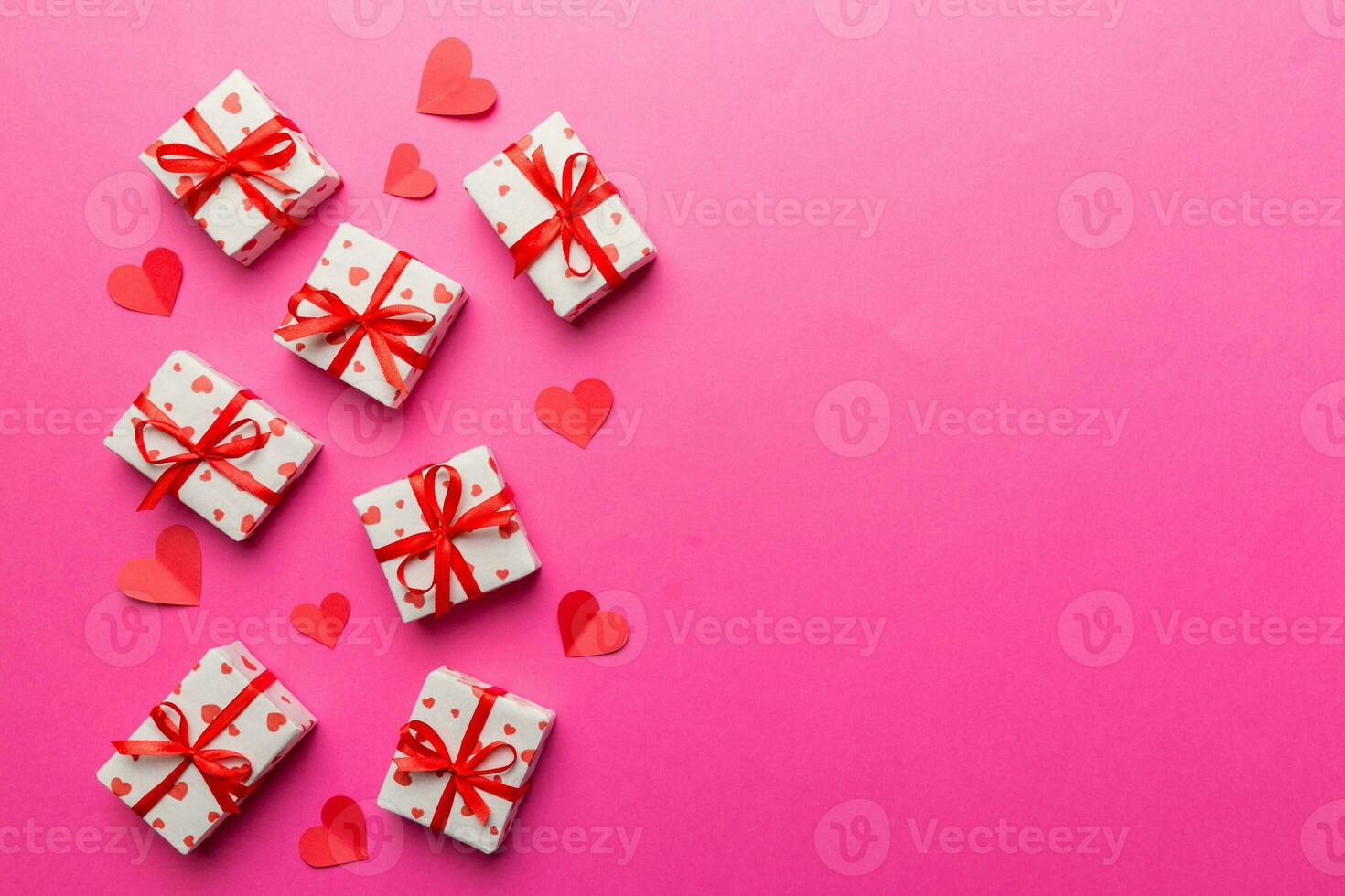 Valentine day composition red  gift box with bow and heart. Christmas present. View from above. Space for text. Holday greeting card photo