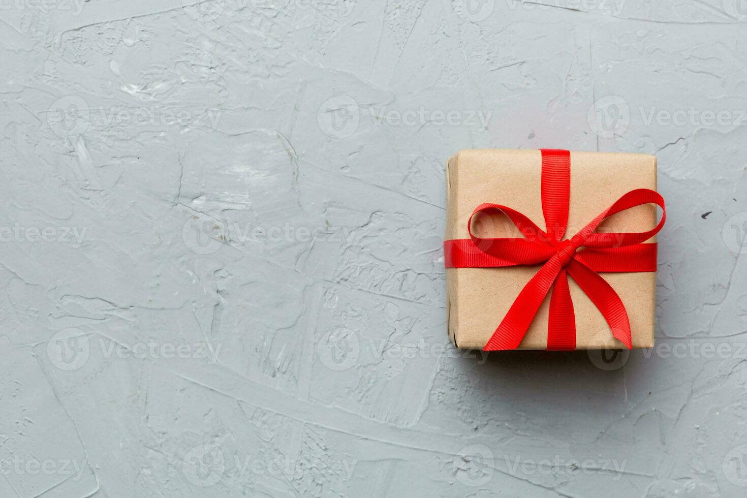 Valentine day composition red gift box with bow and heart. Christmas present. View from above. Space for text. Holday greeting card photo