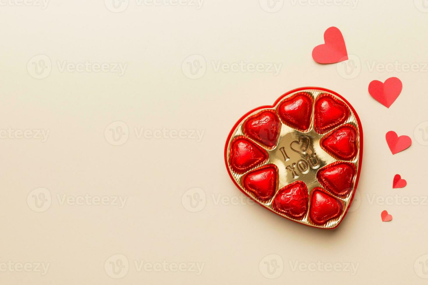 Delicious chocolate pralines in red box for Valentine's Day. Heart shaped box of chocolates top view with copy space photo