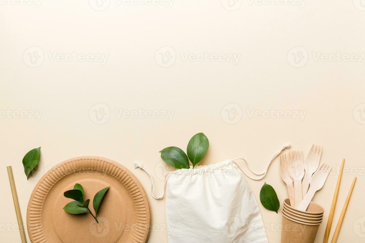 set of empty reusable disposable eco-friendly plates, cups, utensils on light white colored table background. top view. Biodegradable craft dishes. Recycling concept. Close-up photo