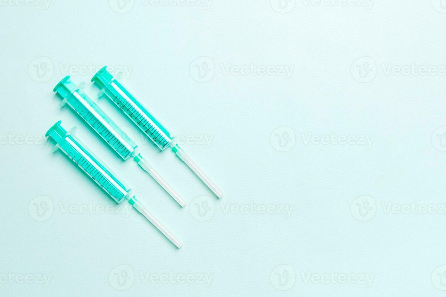 Top view of medical syringes on colorful background with copy space. Injection equipment concept photo