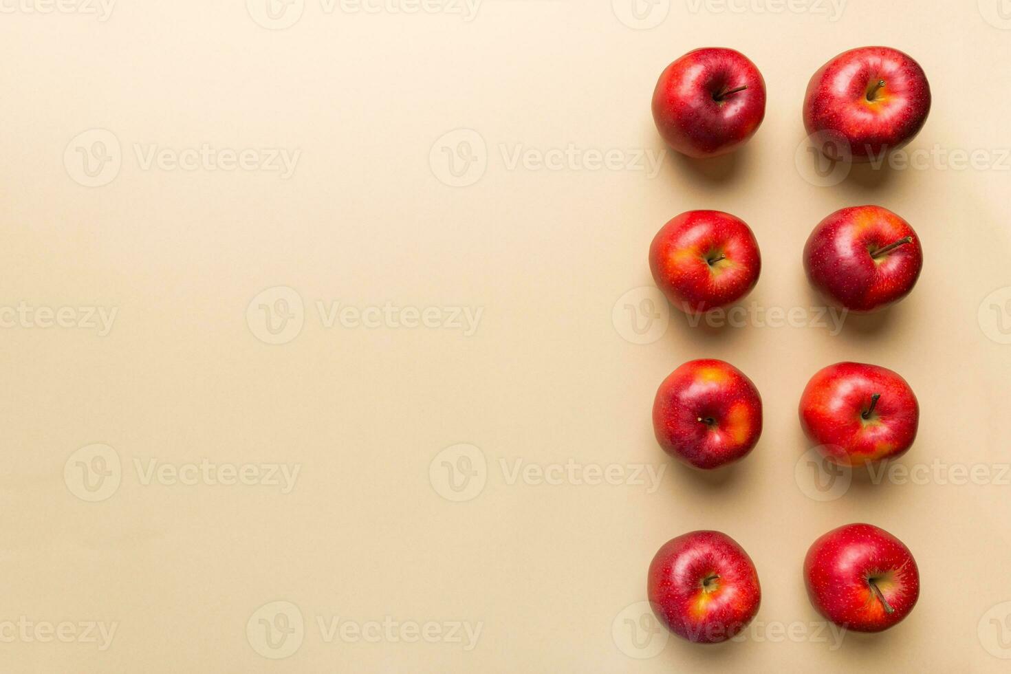 Many red apples on colored background, top view. Autumn pattern with fresh apple above view with copy space for design or text photo