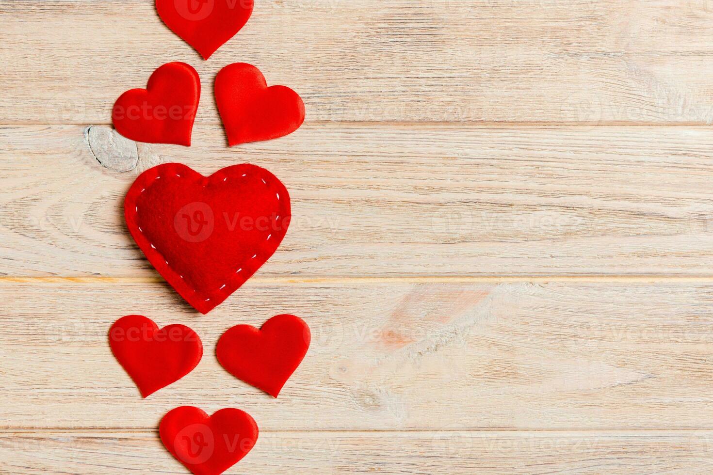 Top view of red hearts on wooden background with copy space. Romantic concept. Valentine's day concept photo