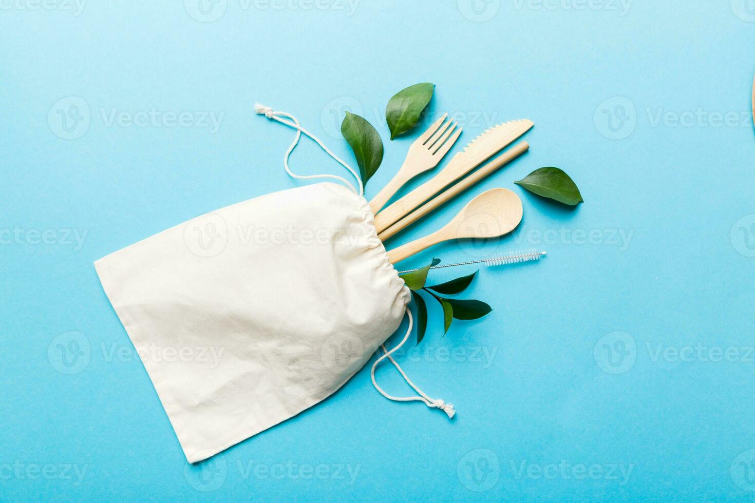 Eco friendly reusable recyclable white eco bag with kitchenware on Colored background. Concept zero waste photo