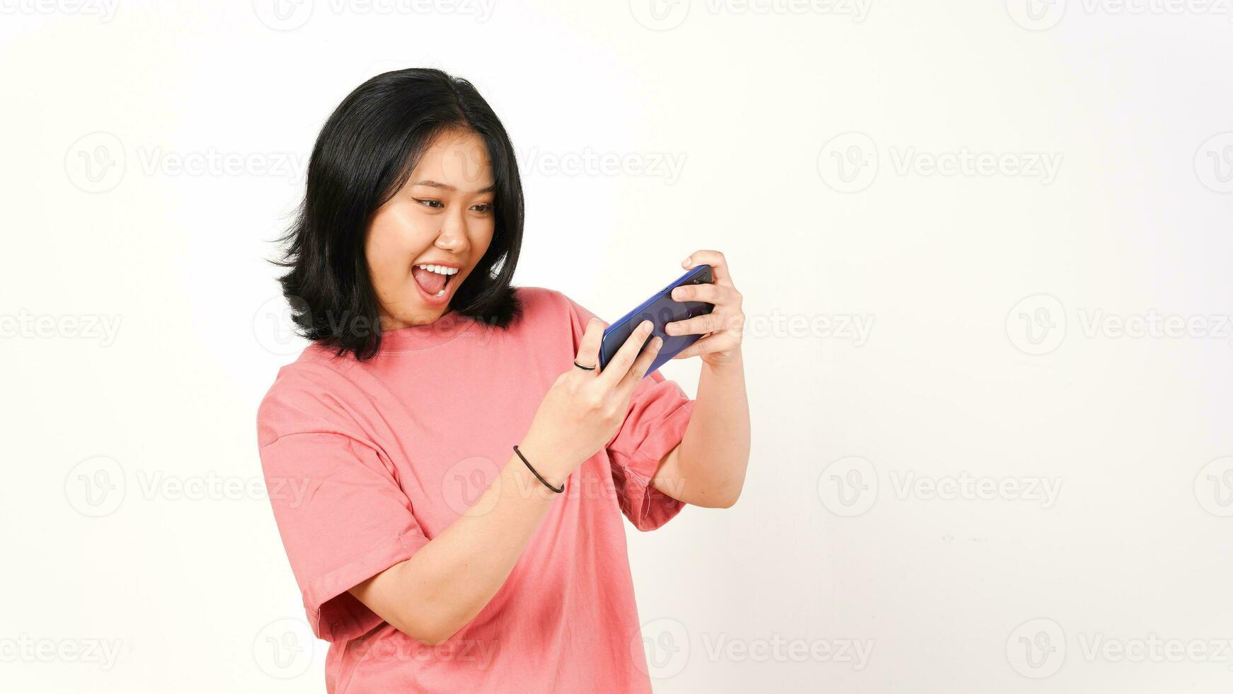 Happy asian woman playing game using mobile phone isolated on a white background. photo