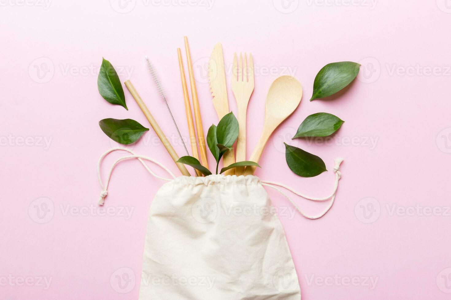 Eco friendly reusable recyclable white eco bag with kitchenware on Colored background. Concept zero waste photo