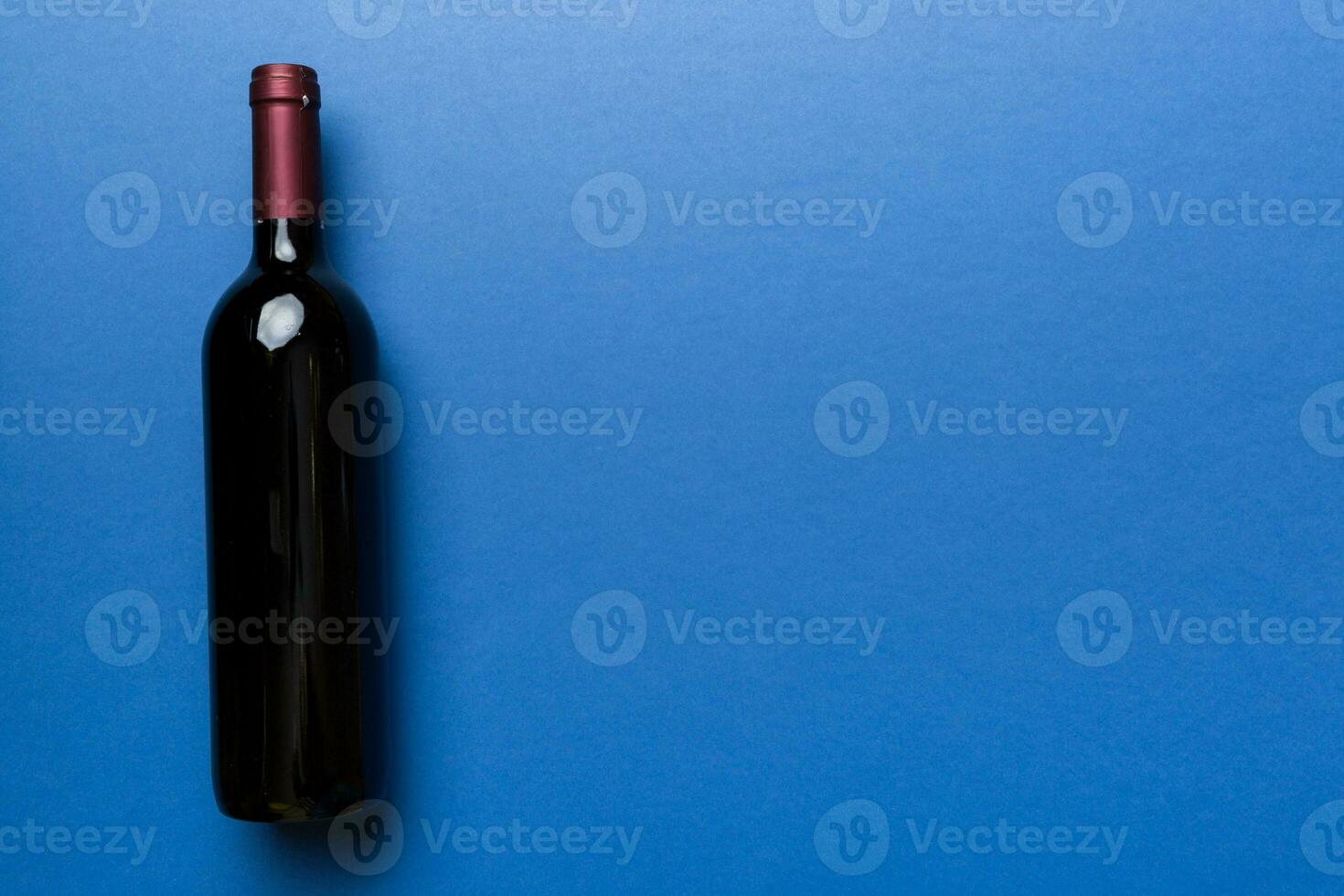 One Bottle of red wine on colored table. Flat lay, top view wth copy space 35982083 Stock Photo ...