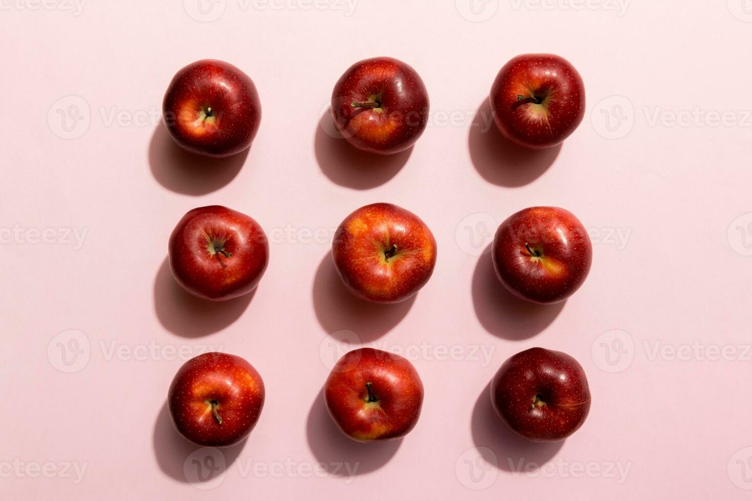 Many red apples on colored background, top view. Autumn pattern with fresh apple above view photo