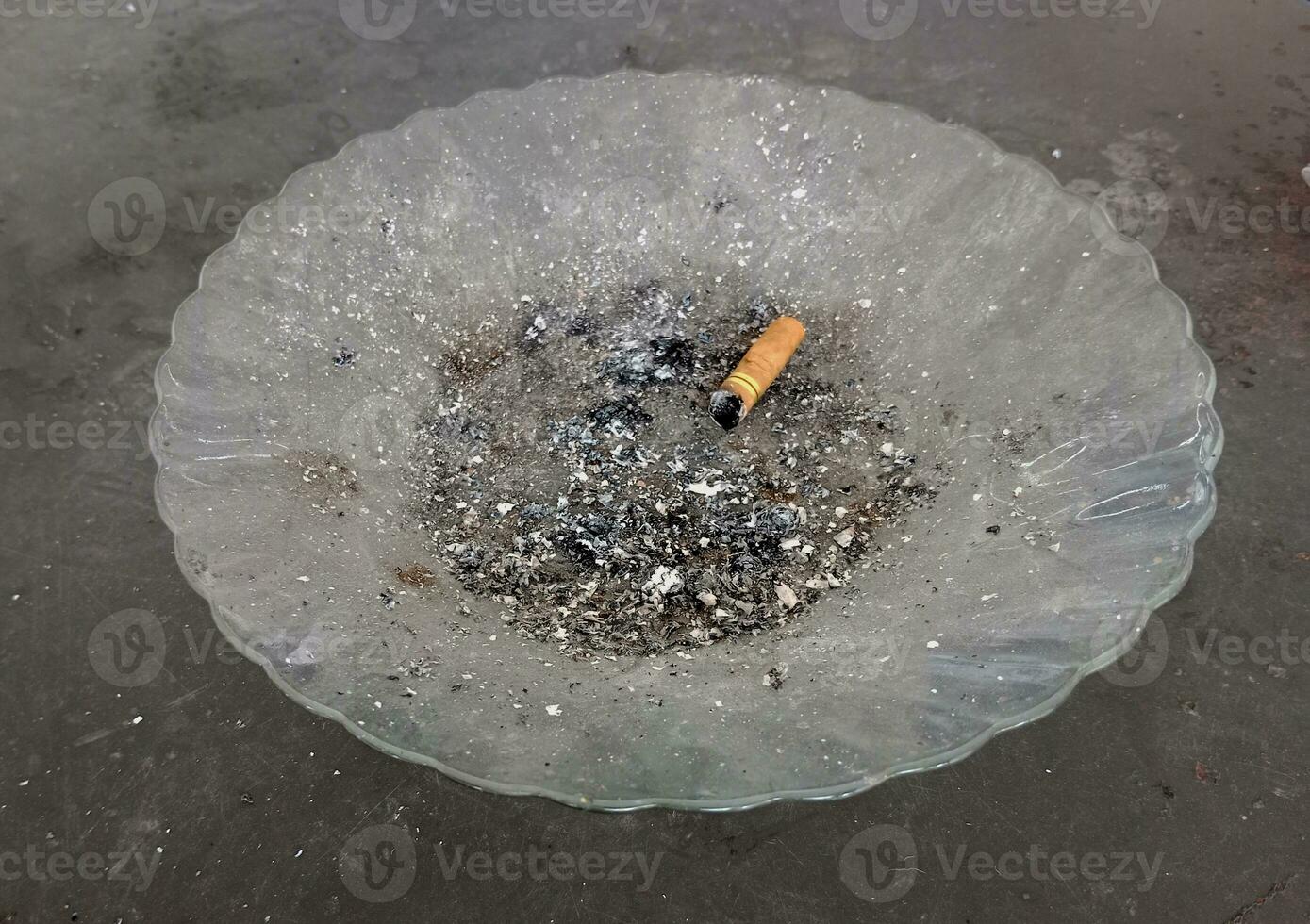 burn out cigarette. cigarette ash on a plate photo