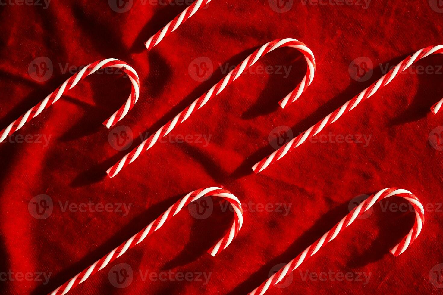 Christmas candy canes on burgundy velvet background. photo