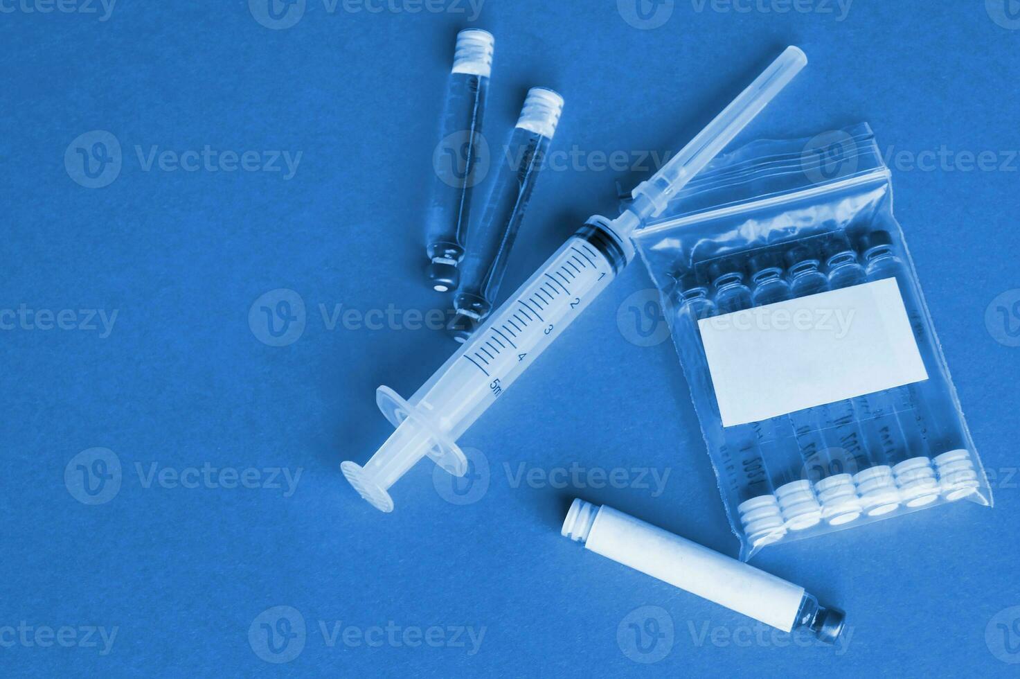Vials with a cure for the disease, 3 ml, a plastic syringe with a needle. photo