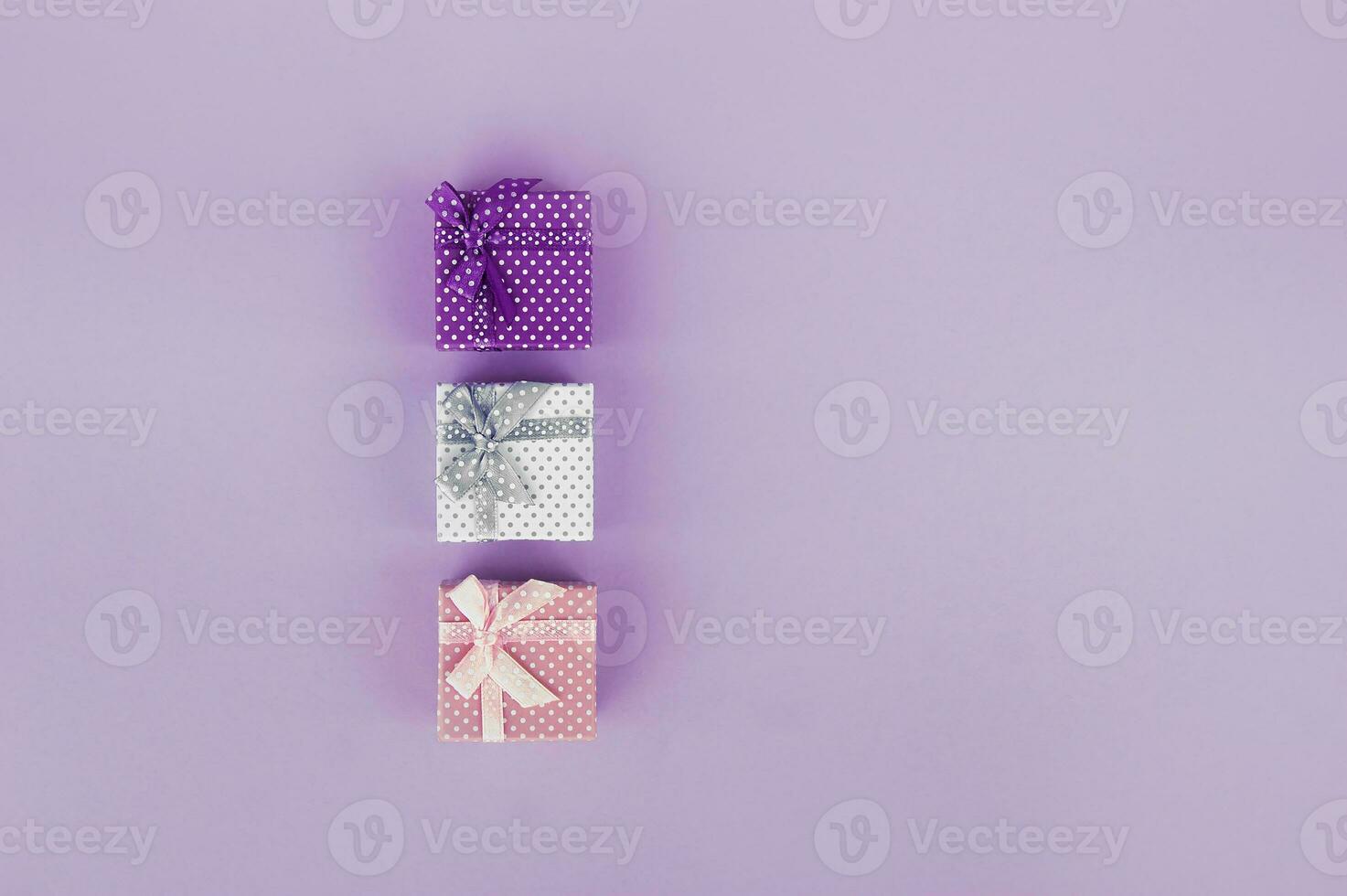 Three gifts on a pink background. Copy space. photo