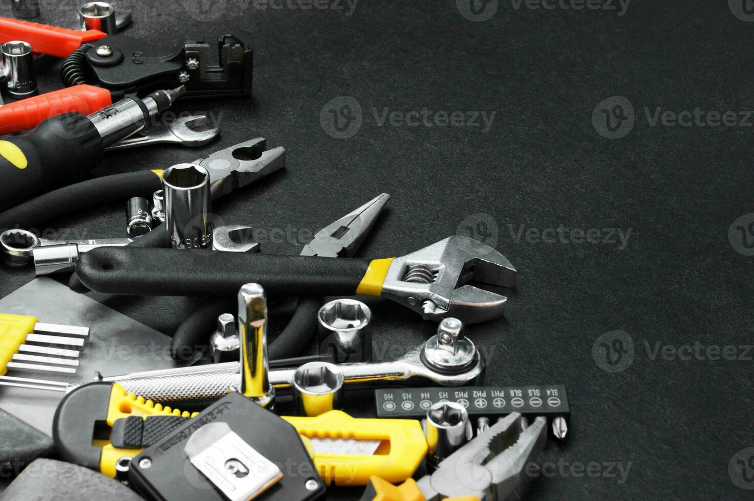 Many different tools for repair work on a black background with copy space for text. photo