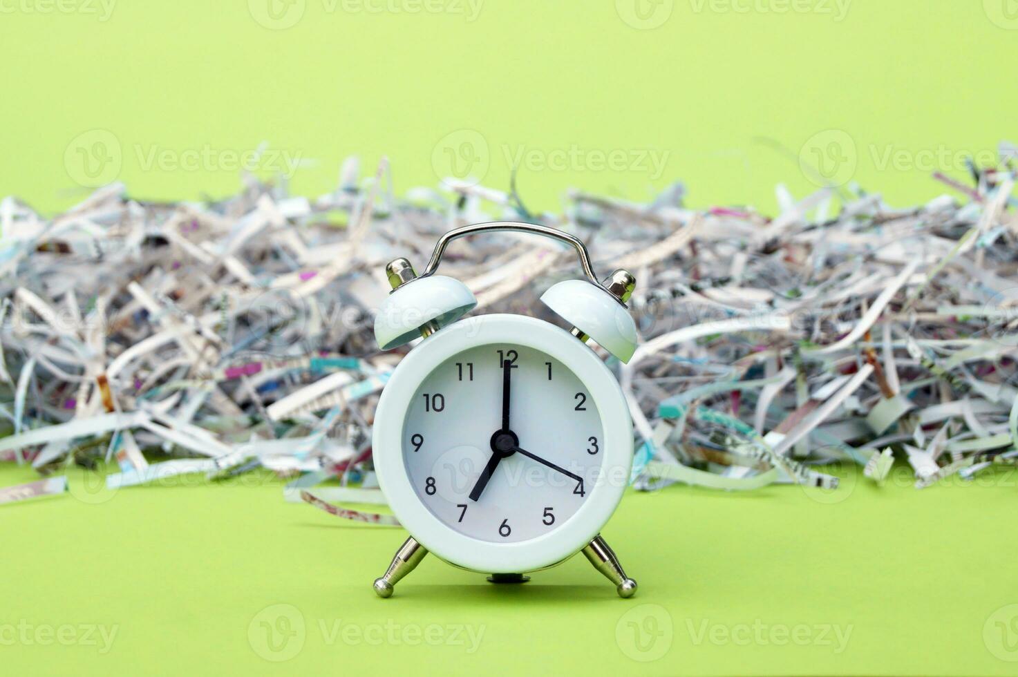 A white vintage clock in the foreground of 700 am on a light green background. photo