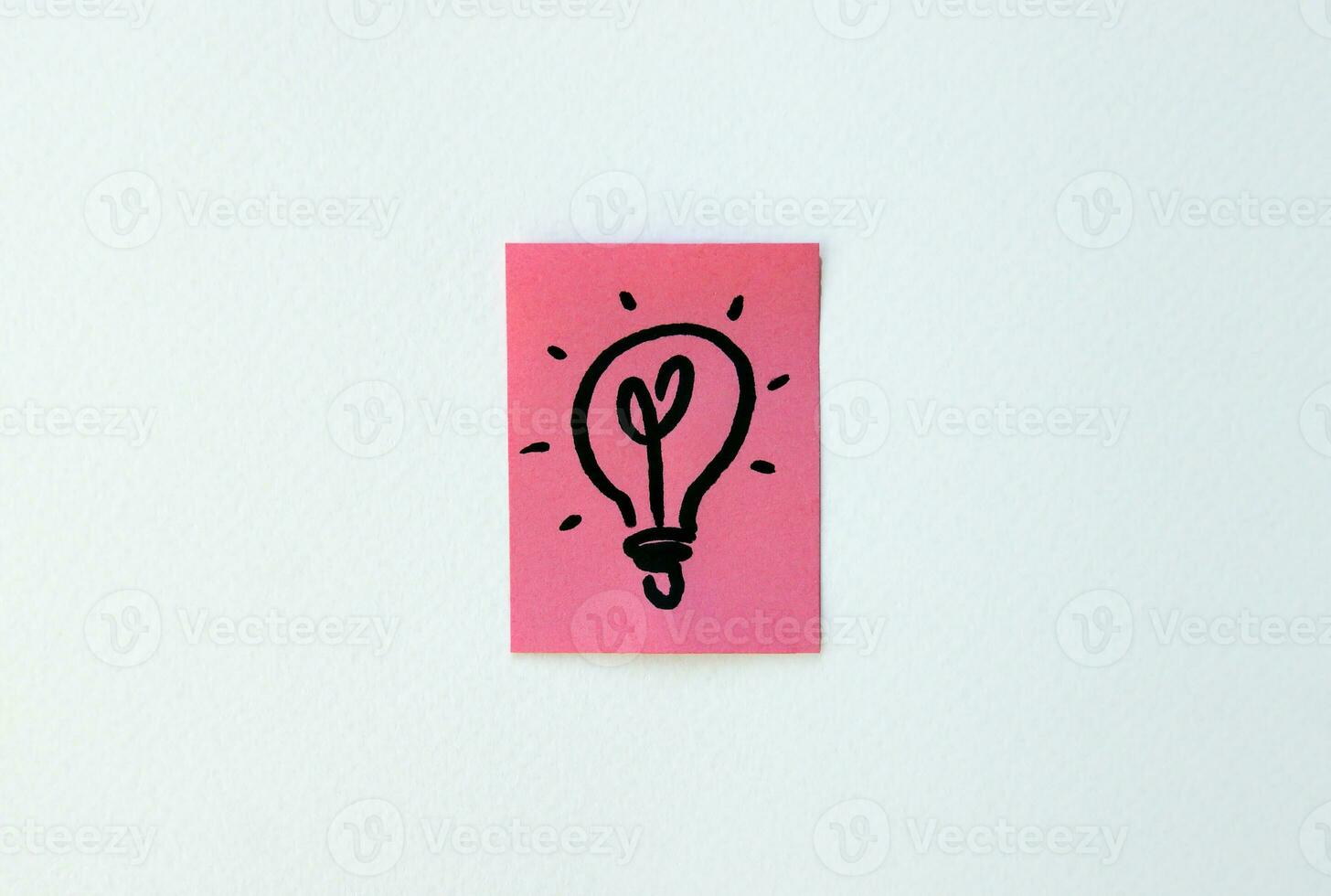 On the pink sheet is painted a lamp as a symbol of ideas and insight. photo