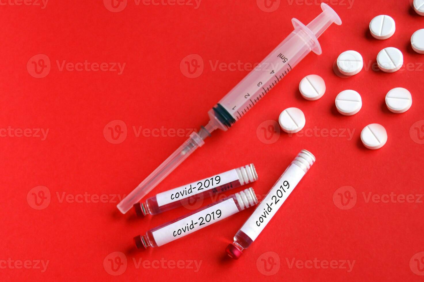 Covid-2019 concept. Syringe and ampoules with a vaccine against the virus. photo
