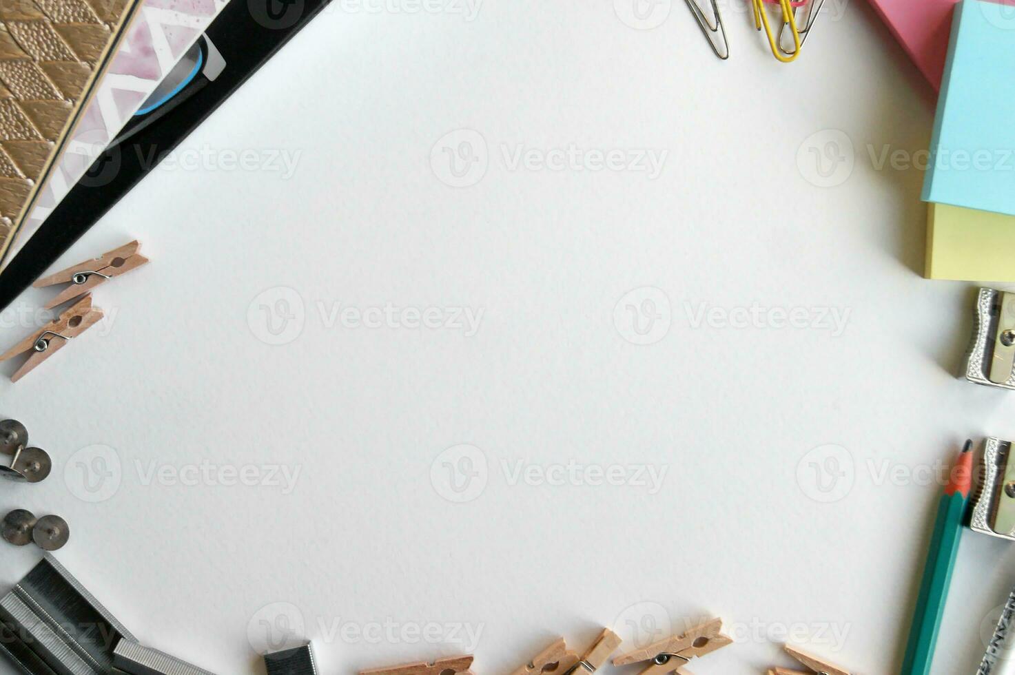 Small office supplies lie on the desktop and form a space in the middle. photo