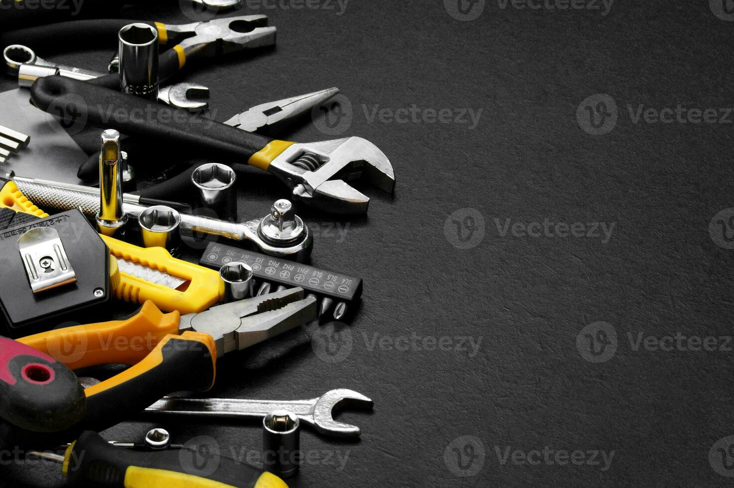 Many different tools for repair work on a black background with copy space for text. photo